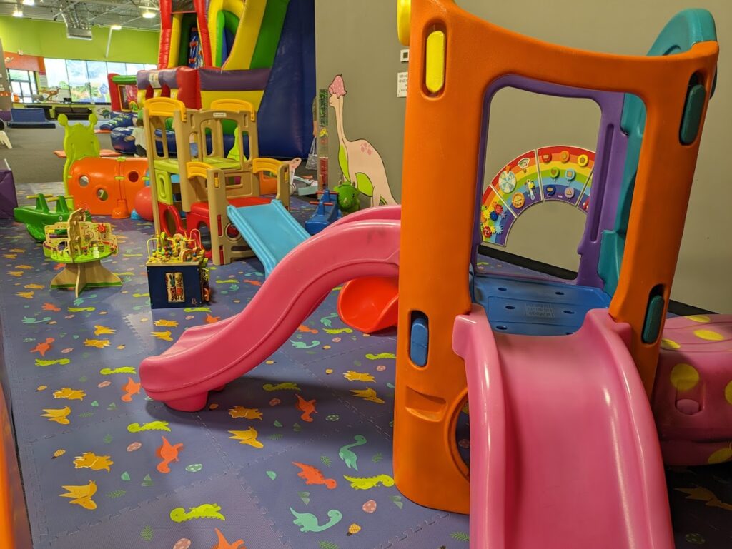 Toddler play area with small slides and colorful play equipment