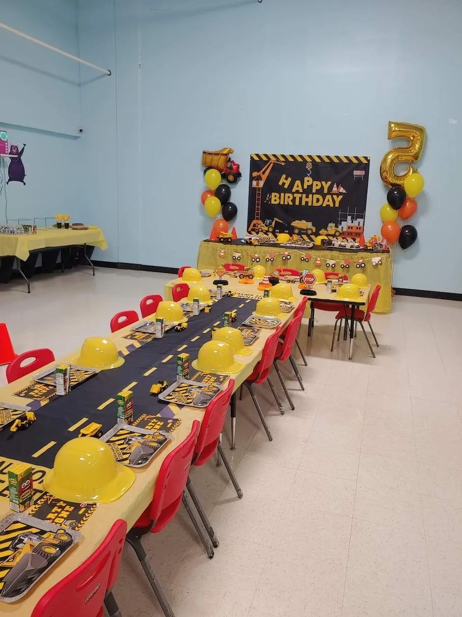 DinoDash birthday party room setup with colorful tables